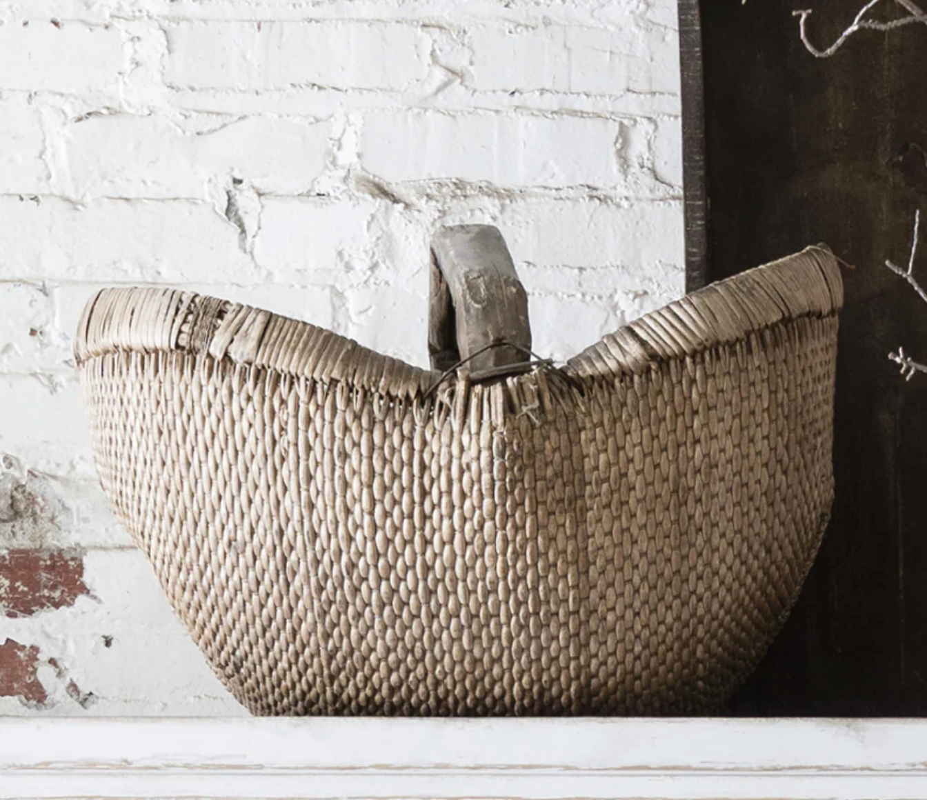 Vintage Round Handle Willow Basket from Qingdao, China with a handwoven form, large integrated handle, and naturally aged patina.