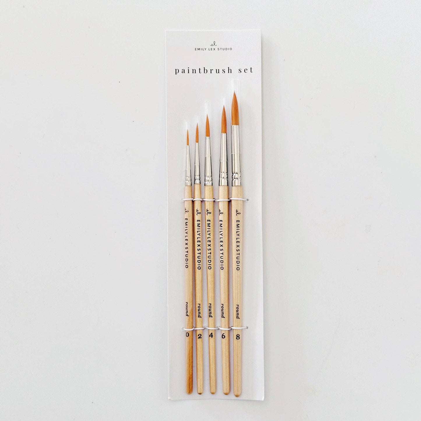 Set of five watercolor paintbrushes with wood handles and synthetic Taklon bristles.