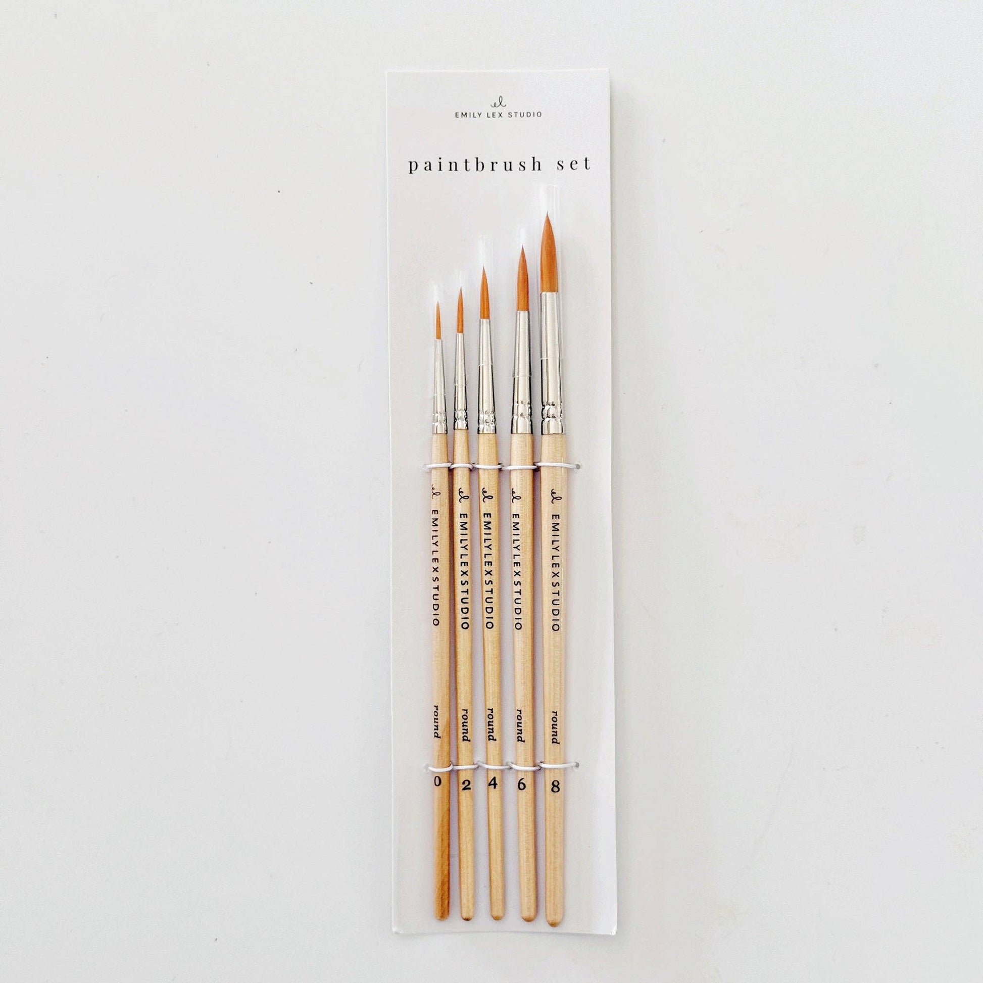 Set of five watercolor paintbrushes with wood handles and synthetic Taklon bristles.