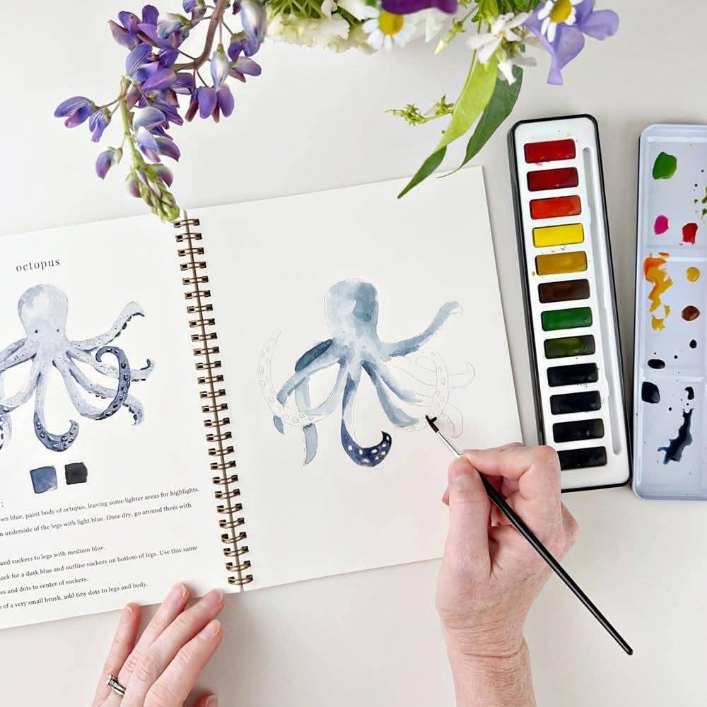 Emily Lex watercolor supplies displayed for a relaxing creative painting session.