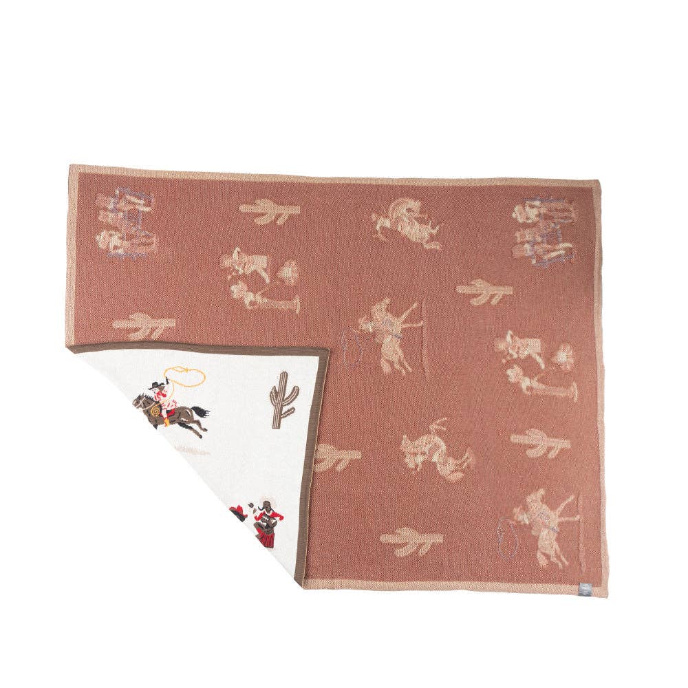 Close-up of the woven cotton texture showcasing detailed frontier scenes and rich Southwestern motifs.