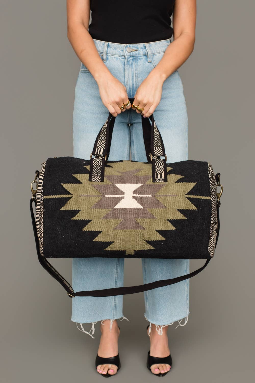 Detail of the sturdy contrasting handles on the Western geometric cotton duffel bag.