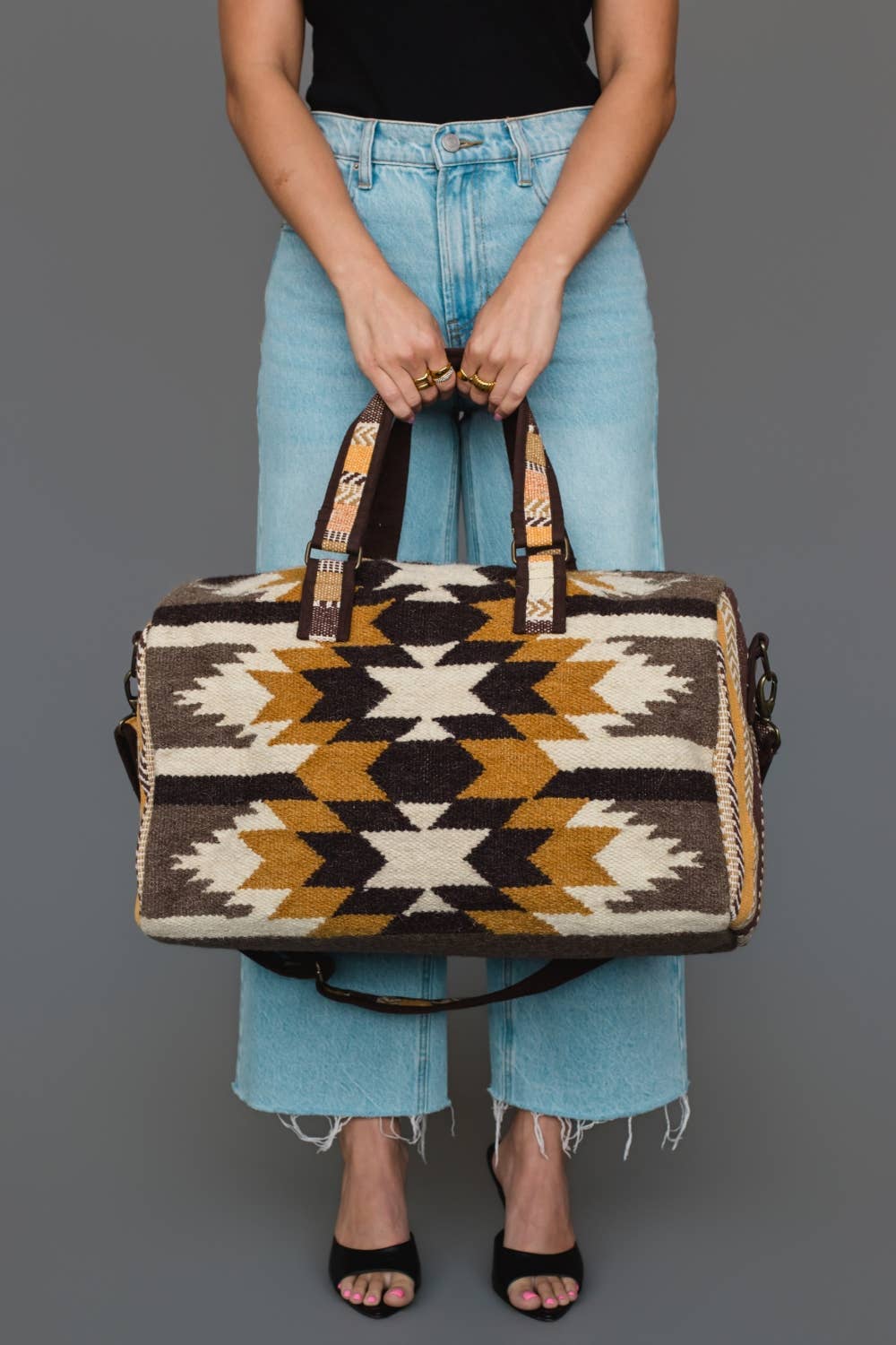 Western geometric cotton duffel bag styled with travel essentials for a weekend getaway.