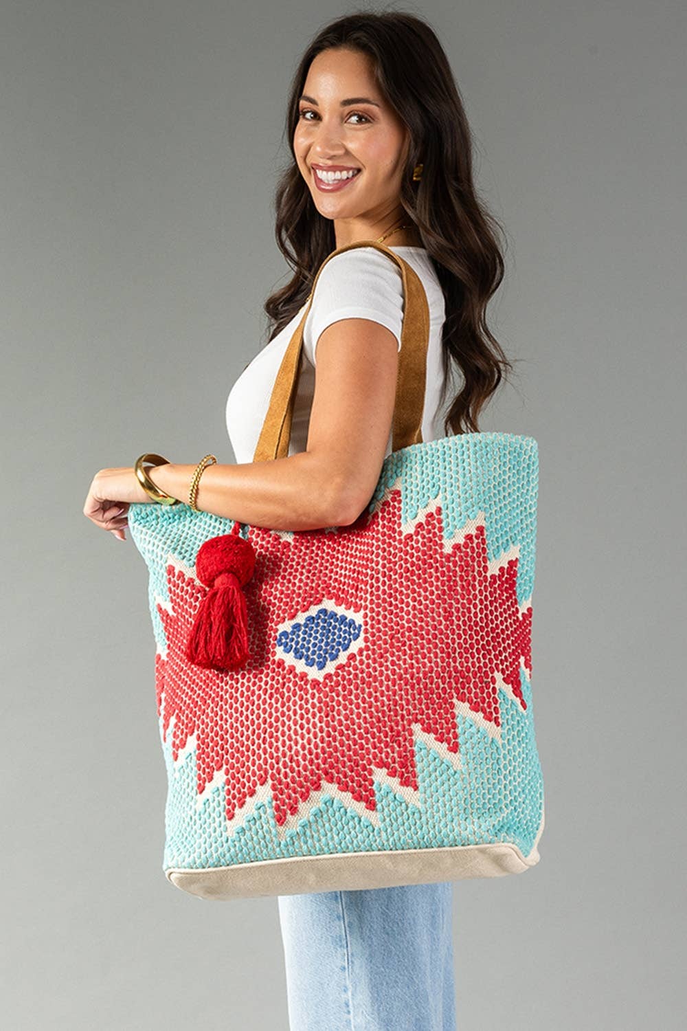 Red, turquoise, and blue Western geometric tote carried over the shoulder for everyday outings.