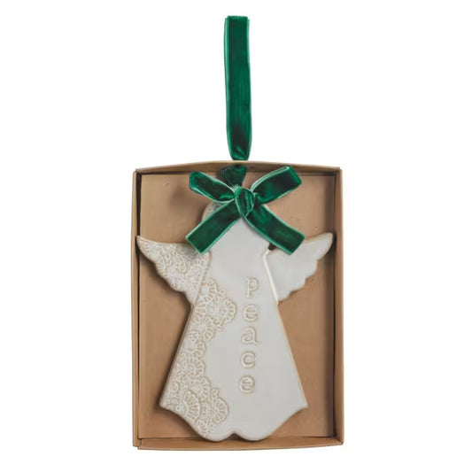White stoneware angel ornament with a reactive glaze finish and velvet ribbon.