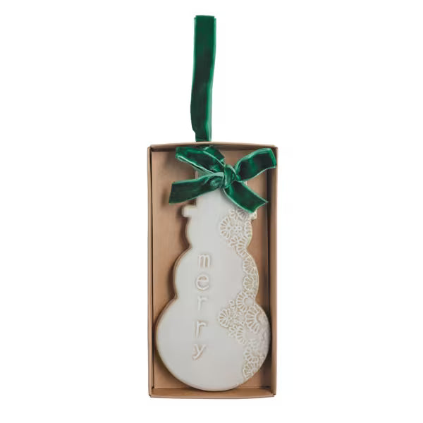 White stoneware snowman ornament with a reactive glaze finish and velvet ribbon.
