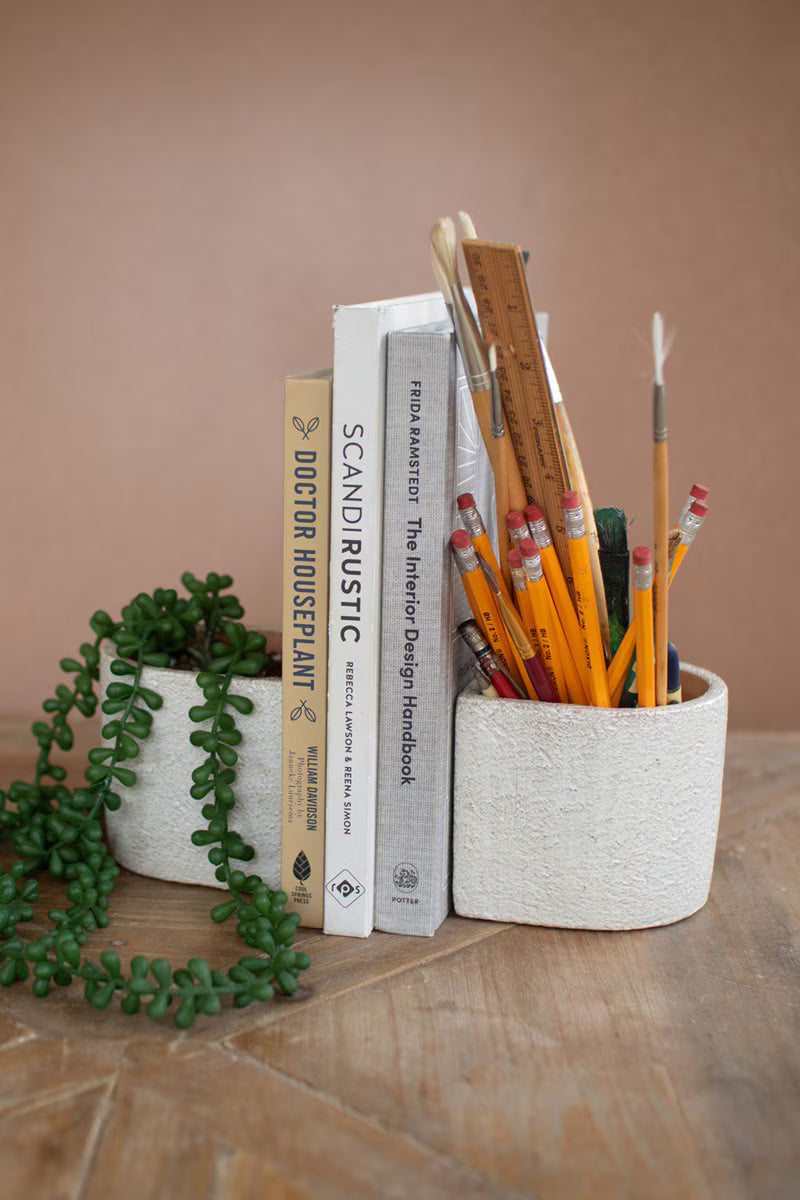Set of two white concrete bookend planters for bookshelves and decorative styling.