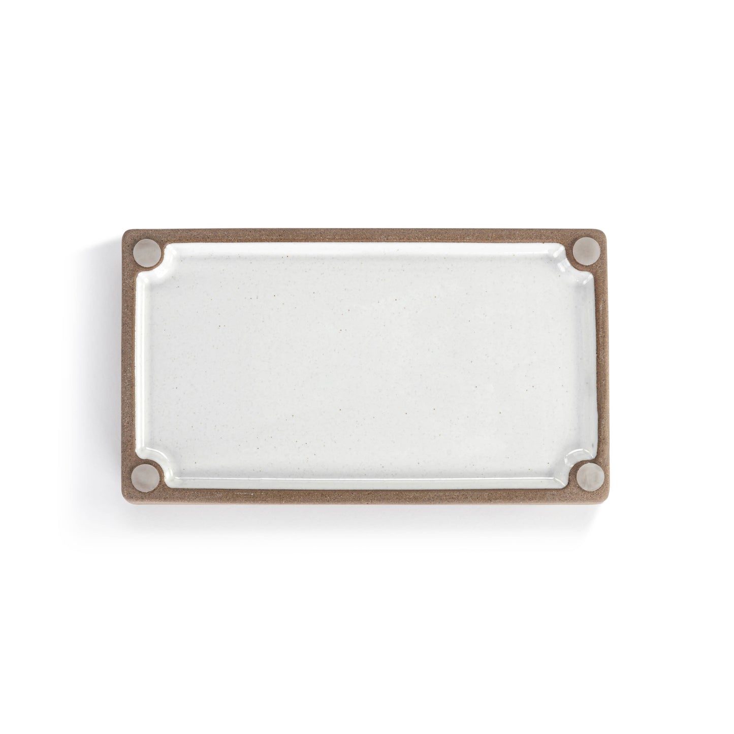 Small ceramic tray with a white and natural finish for decorative organization.