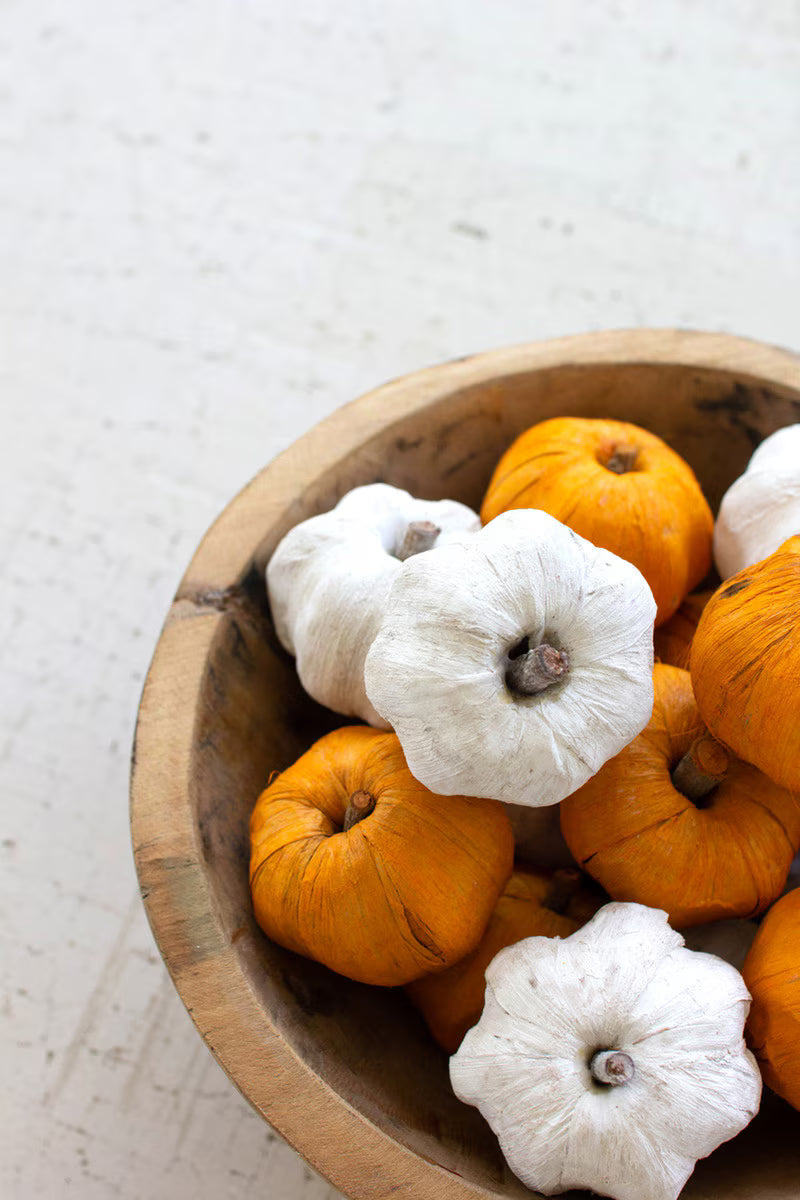 Close-up of white faux pumpkins with natural variation in size, shape, and texture.