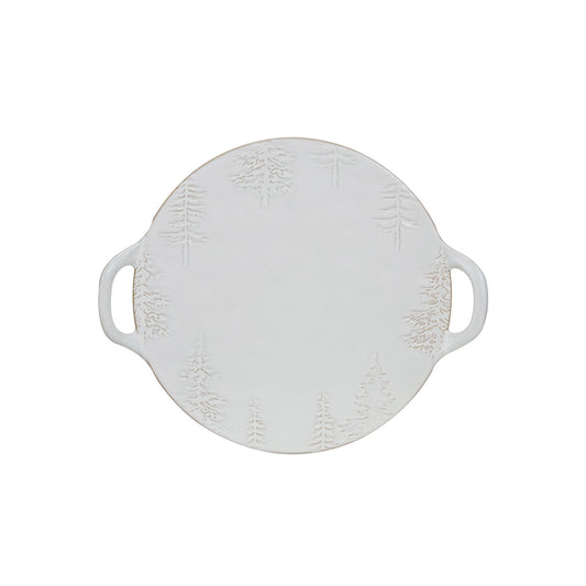 White stoneware serving platter with debossed evergreen trees, integrated handles, and a softly varied reactive glaze.