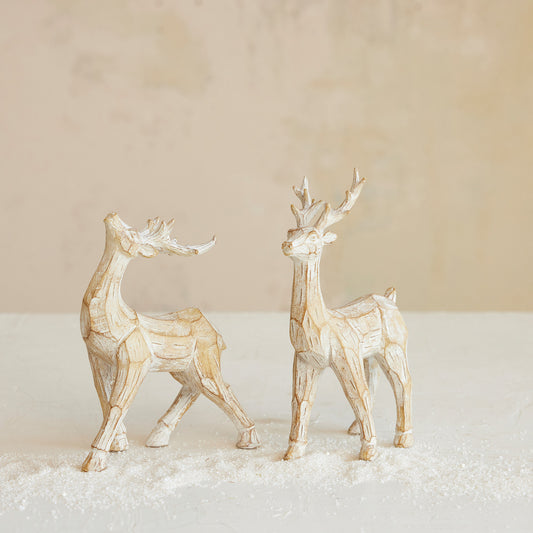 Two whitewashed carved deer figurines in Looking Up and Standing poses with an aged wood-inspired finish.