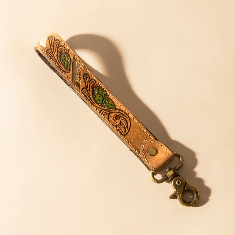 Wildvine Pony hand-tooled tan leather key fob with genuine hair-on hide and green cactus detailing.