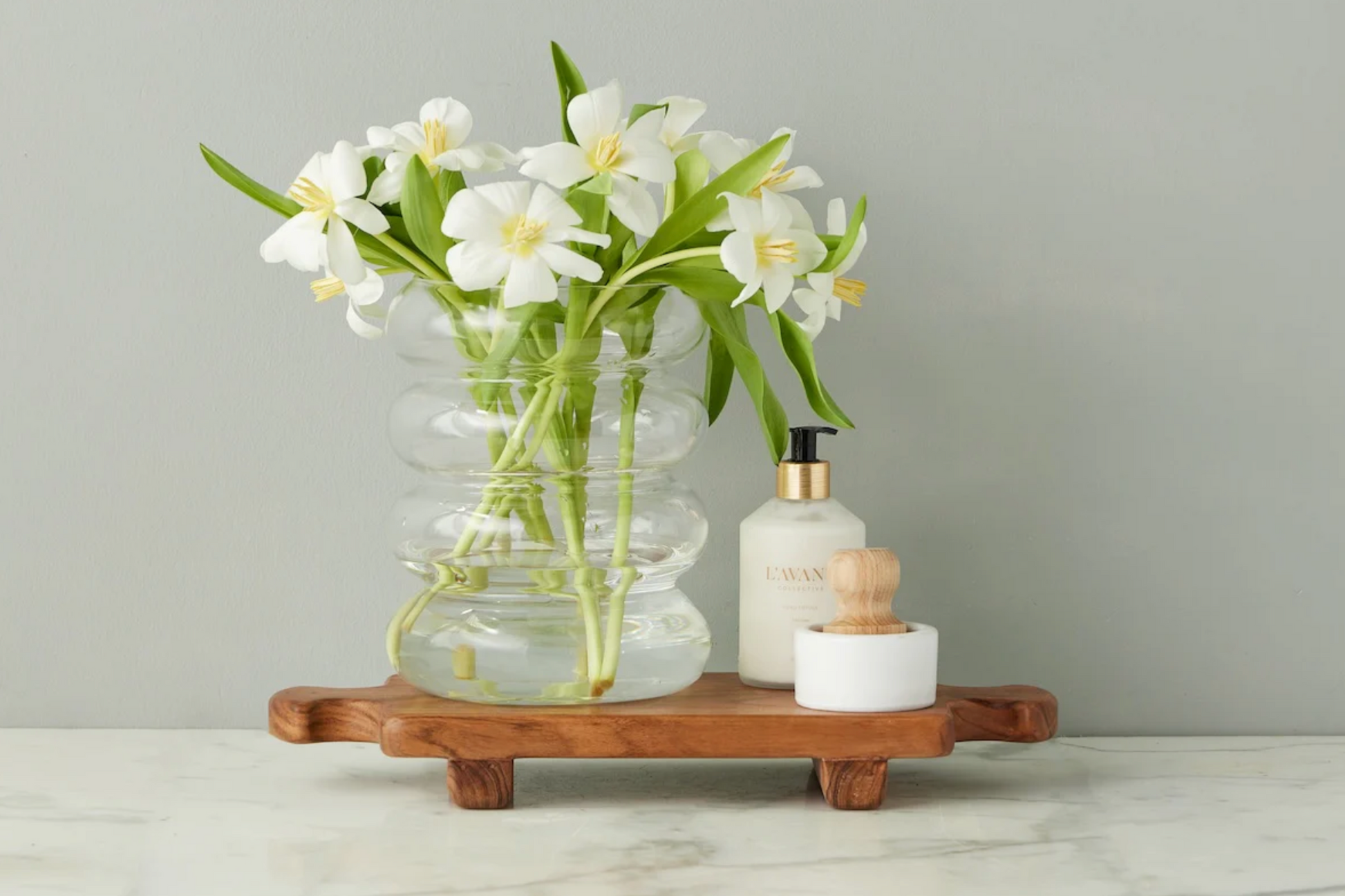Small Normandy wood riser footed tray crafted from acacia wood styled on a warm collected kitchen counter