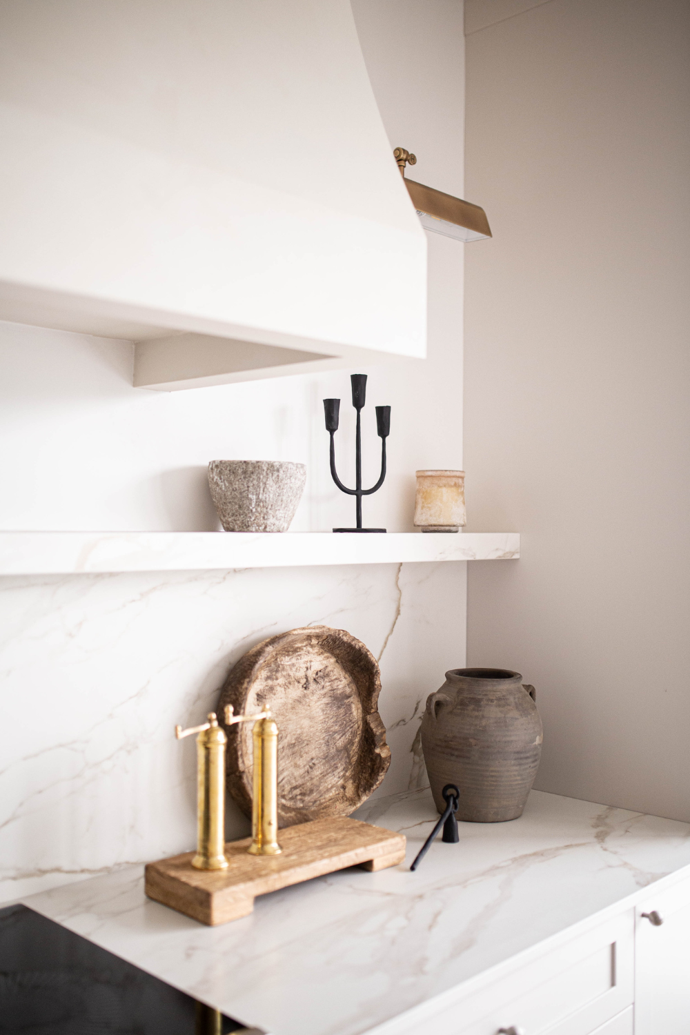 Reclaimed elm wood trivet riser styled with candles and kitchen essentials on countertop