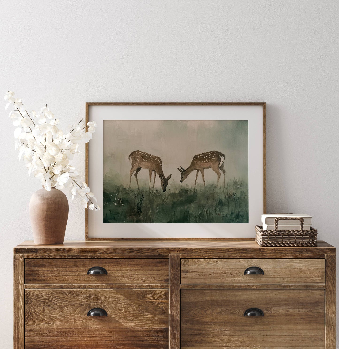 Field of Deer Art Print displayed above a wood console with ceramic vases, greenery, and warm organic modern décor.