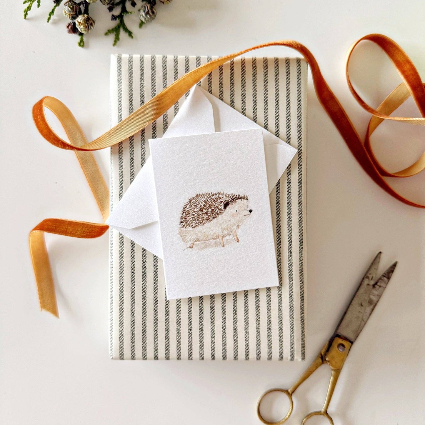 Woodland-inspired mini enclosure card attached to a wrapped gift.