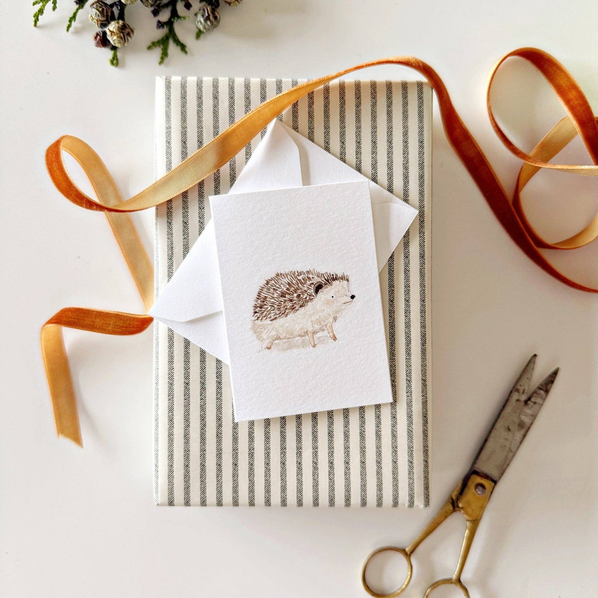 Woodland-inspired mini enclosure card attached to a wrapped gift.