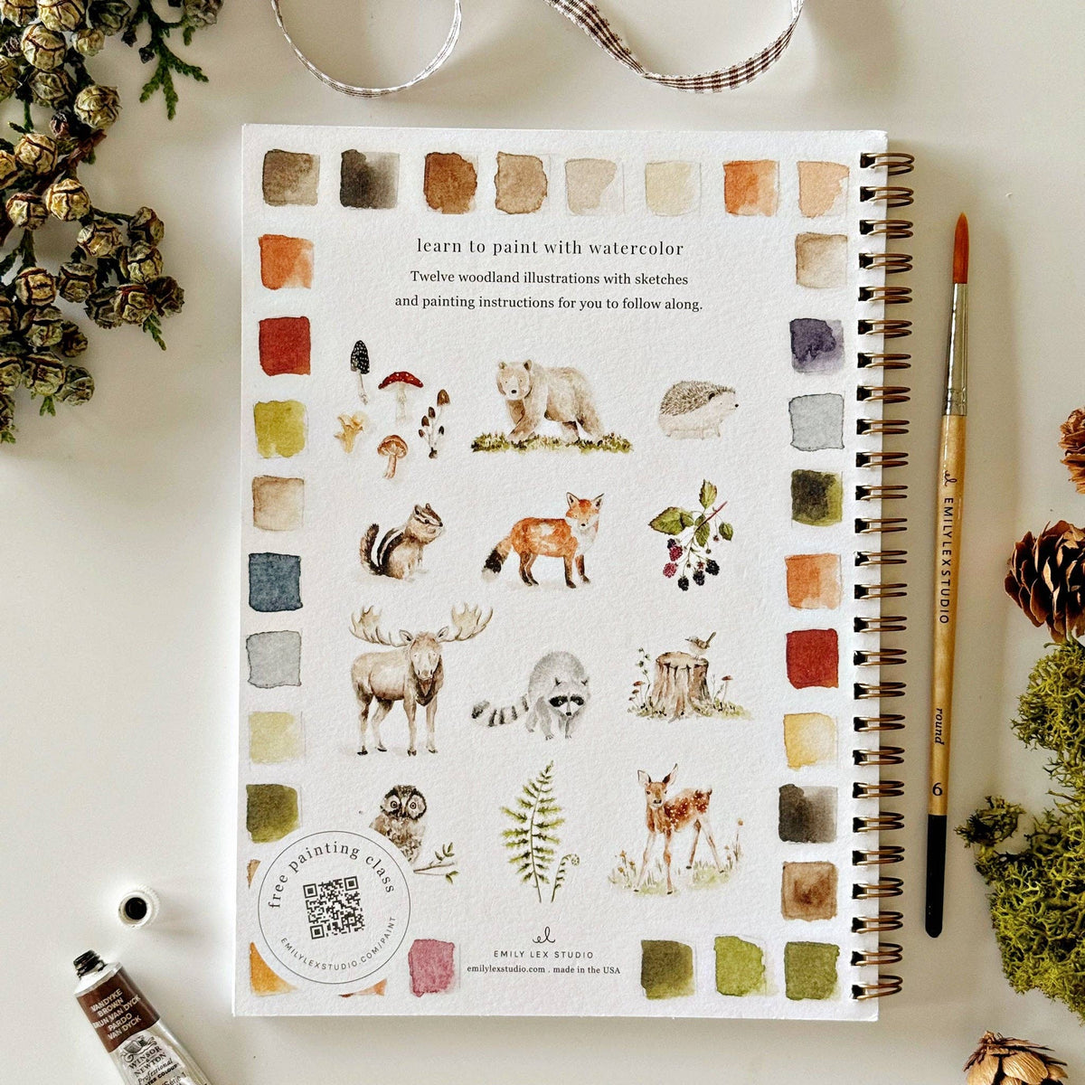Woodland Watercolor Workbook featuring beginner-friendly pre-outlined nature-inspired watercolor projects.