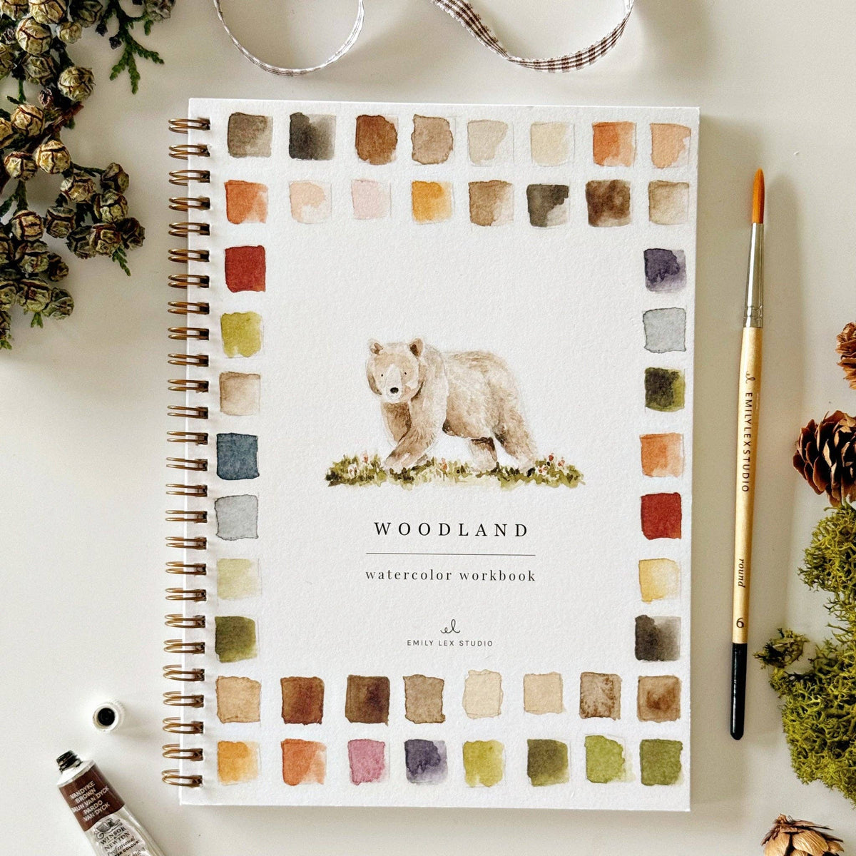 Woodland Watercolor Workbook featuring beginner-friendly pre-outlined nature-inspired watercolor projects.