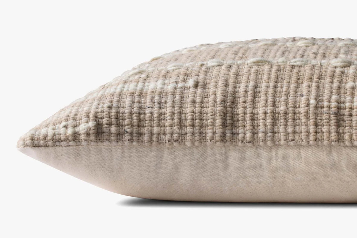 Close-up of the handwoven wool and cotton pillow showcasing the artisan texture, hidden zipper with antique bronze Loloi logo pull, and neutral woven fibers.