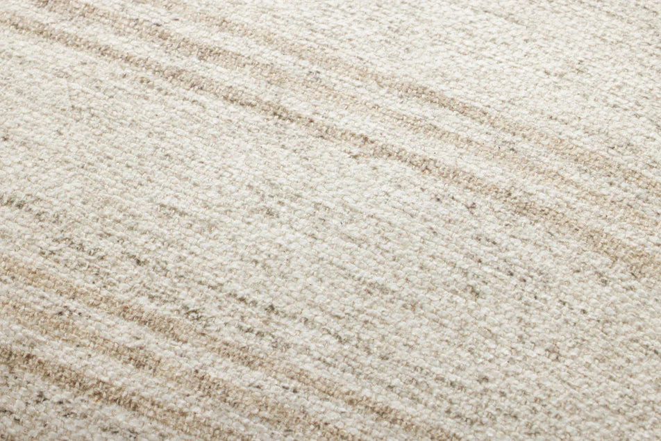 Close-up of the woven polyester and cotton texture on the Amber Lewis Zephyr pillow in ivory and natural.